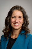 portrait of woman smiling in purple suit