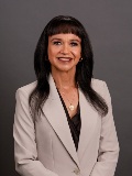 portrait of woman smiling wearing a suite 