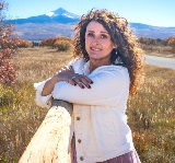 Candy Meehan, Mayor of Norwood, photographed outdoors with a mountain backdrop.